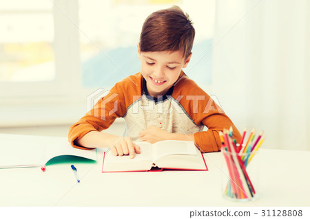 smiling, student boy reading book at home 31128808