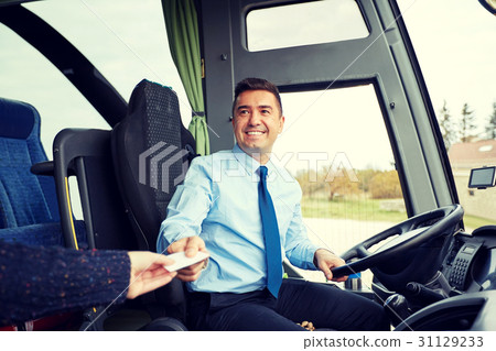 bus driver taking ticket or card from passenger 31129233