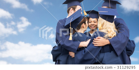 happy students or bachelors hugging over blue sky 31129295