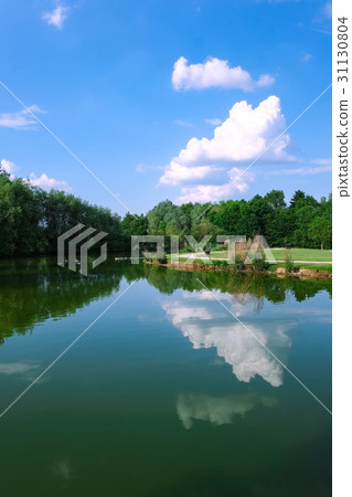 Summer sky reflected on the lake surface 31130804