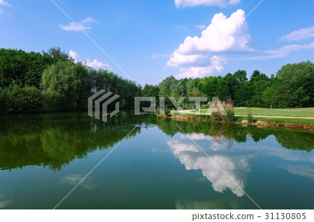 Summer sky reflected on the lake surface 31130805