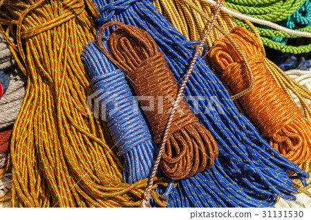 Many multicolored ropes lie on the ground Many multicolored ropes lie on the ground 31131530