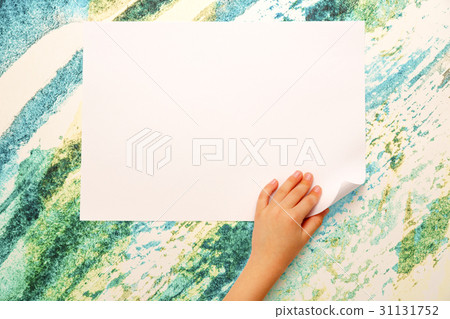Child's hand turning over paper Child's hand turning over paper 31131752