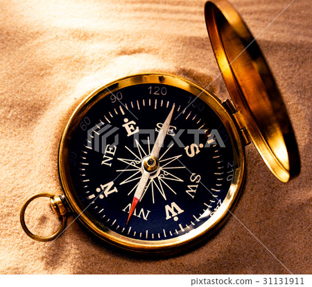 Golden compass with beach sand Golden compass with beach sand 31131911