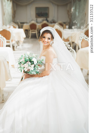 Beautiful bride with wedding bouquet posing in Beautiful bride with wedding bouquet posing in 31133522