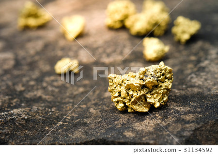 A lump of gold on a stone floor A lump of gold on a stone floor 31134592