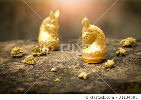 Vintage chess horse in gold and gold on old stone Vintage chess horse in gold and gold on old stone 31134593