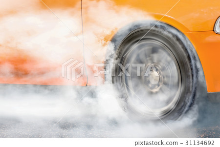 Drag racing car burns tire for the race Drag racing car burns tire for the race 31134692