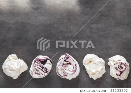 White and purple swirl meringues on gray  31135892