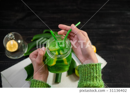 Drink with fresh lemon,kiwi, orange from bottle  Drink with fresh lemon,kiwi, orange from bottle  31136402