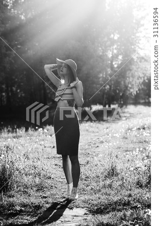 Silhouette of girl walking in park outdoor. Sunny 31136594