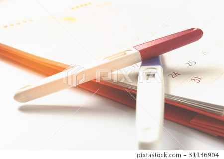 Pregnancy test with positive result on calendar Pregnancy test with positive result on calendar 31136904