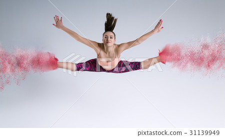 Woman in jump in studio and disintegration effect 31139949