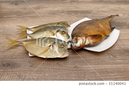 Smoked and dried fish on wooden background. Smoked and dried fish on wooden background. 31140041