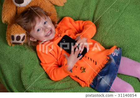 little girl lying on a big green pillow little girl lying on a big green pillow 31140854