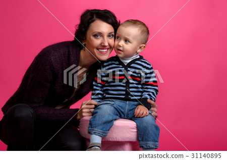 Portrait of  baby and his mother on a pink  31140895