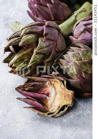 Uncooked purple artichokes Uncooked purple artichokes 31143451