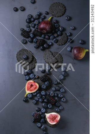 Variety of berries and figs with black crackers 31143492