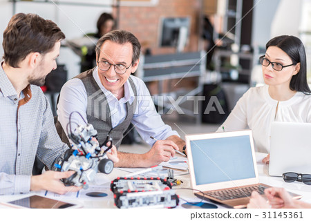 Positive team constructing modern device Positive team constructing modern device 31145361