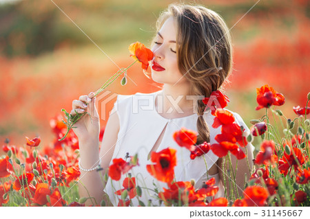 Beautiful girl in field of poppy flowers, spring Beautiful girl in field of poppy flowers, spring 31145667