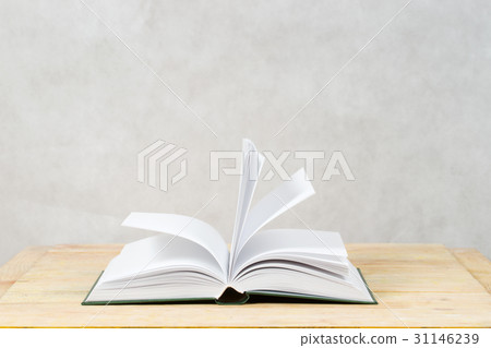 Open book on wooden table. 31146239