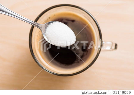 Pouring sugar into coffee cup Pouring sugar into coffee cup 31149099