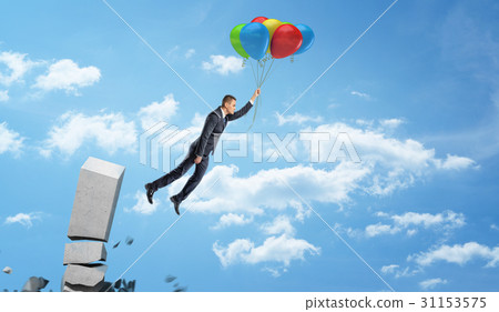 A businessman holding a set of colorful balloons A businessman holding a set of colorful balloons 31153575