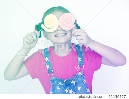 Little girl playful happiness with lollipop Little girl playful happiness with lollipop 31156557
