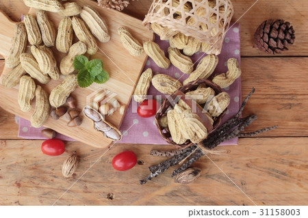 Peanut and boiled peanuts on wood background. 31158003