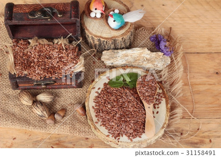 Flax seeds for health on wood background Flax seeds for health on wood background 31158491