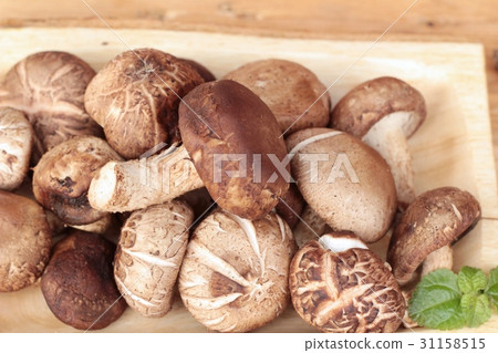 Shiitake mushrooms for cooking on wood background. 31158515