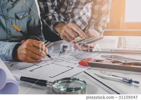 Two colleagues interior designer discussing data 31159347