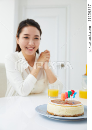 A 30 year old woman celebrating birthday A 30 year old woman celebrating birthday 31159857