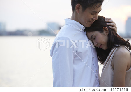 a man is hugging his girlfriend. a man is hugging his girlfriend. 31171316