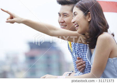 a couple is looking at the same direction. 31171373