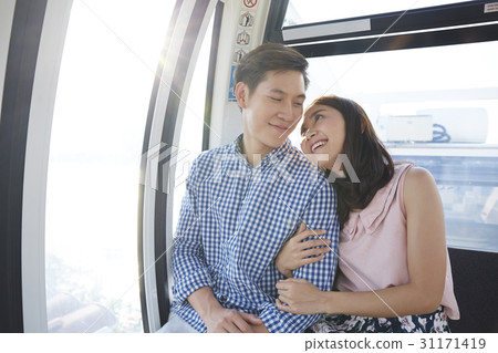 Young couple is smiling and embracing in a cabin. 31171419