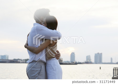 Happy young couple is hugging at the riverside. Happy young couple is hugging at the riverside. 31171449