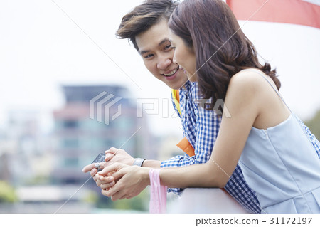 a man is talking something to a woman outdoors a man is talking something to a woman outdoors 31172197