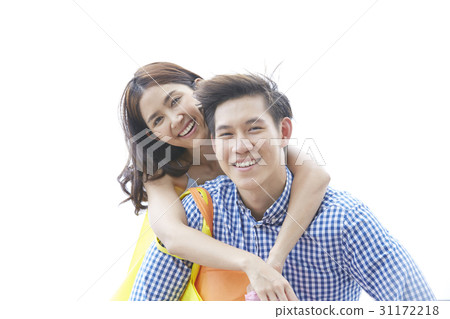 a portrait of a couple smiling with the man carrying the woman on his back a portrait of a couple smiling with the man carrying the woman on his back 31172218