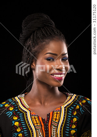 Smiling dark skinned model on a black background. Smiling dark skinned model on a black background. 31175120