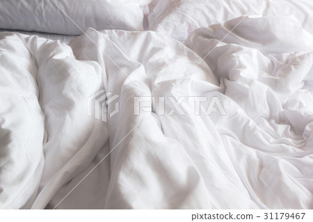 white pillow on bed and with wrinkle messy blanket 31179467