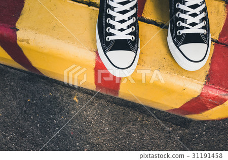 Black and white new sneakers, teenager feet 31191458