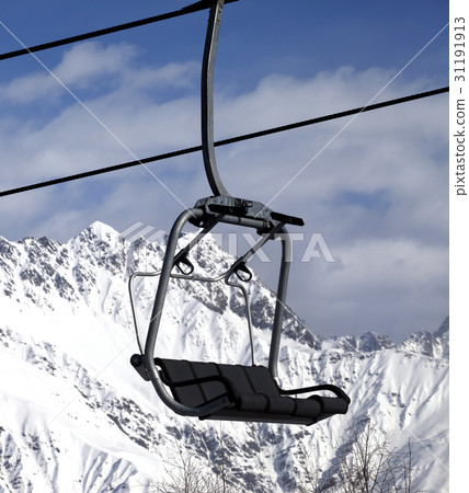 Chair lift in snowy mountains at nice sun day 31191913