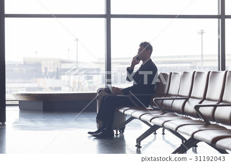 A businessman who works at airport waiting time at the airport 31192043