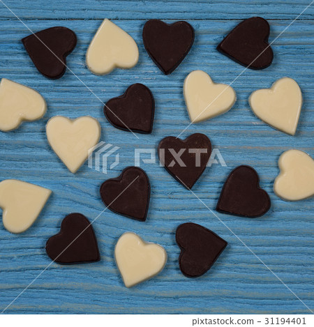 Chocolate hearts on a wooden background 31194401