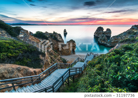Wooden footbridge walkway to beach Praia do Camilo 31197736