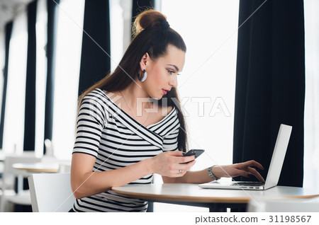 Charming Caucasian woman using mobile phone and Charming Caucasian woman using mobile phone and 31198567