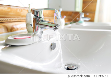 Working mixer tap in the bathroom closeup. water 31199235