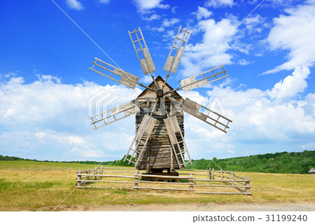 Old wooden windmill against the sky. Old wooden windmill against the sky. 31199240