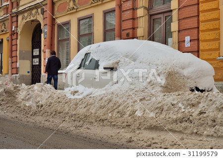 Car covered with snow on the embankment of river 31199579